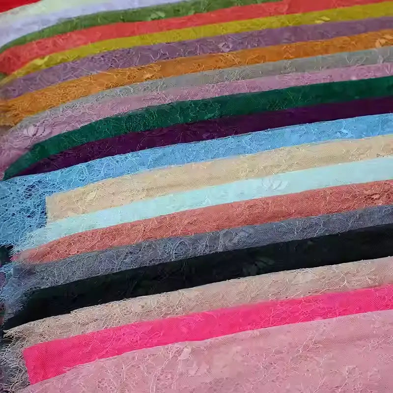 Colorful Floral Embroidered Lace Fabric by Longan Craft, featuring pink, red, green, blue, black, and beige botanical patterns. This vintage scalloped lace is delicate—perfect for wedding gowns and sold by the yard.