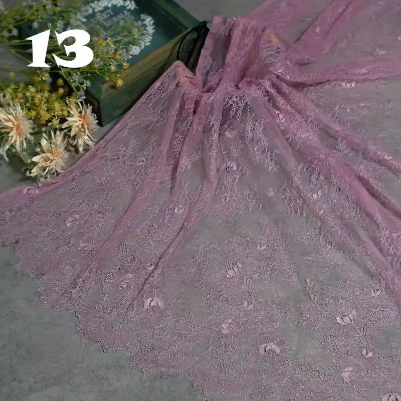 Longan Craft’s Colorful Floral Embroidered Lace Fabric, featuring a vintage scalloped edge and botanical design, is displayed next to flowers and a book. The number “13” appears in white text at the top left.