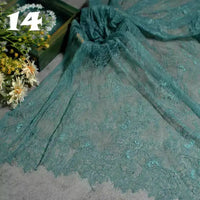 Colorful Floral Embroidered Lace Fabric by Longan Craft, featuring a vintage scalloped botanical pattern, is spread on a grey surface with fresh flowers. The number 14 is visible in the top left corner.