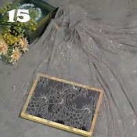 Longan Craft’s Colorful Floral Embroidered Lace Fabric with vintage scalloped edges and botanical patterns drapes over a wooden frame beside a bouquet of flowers, with the number 15 in white in the upper left corner.