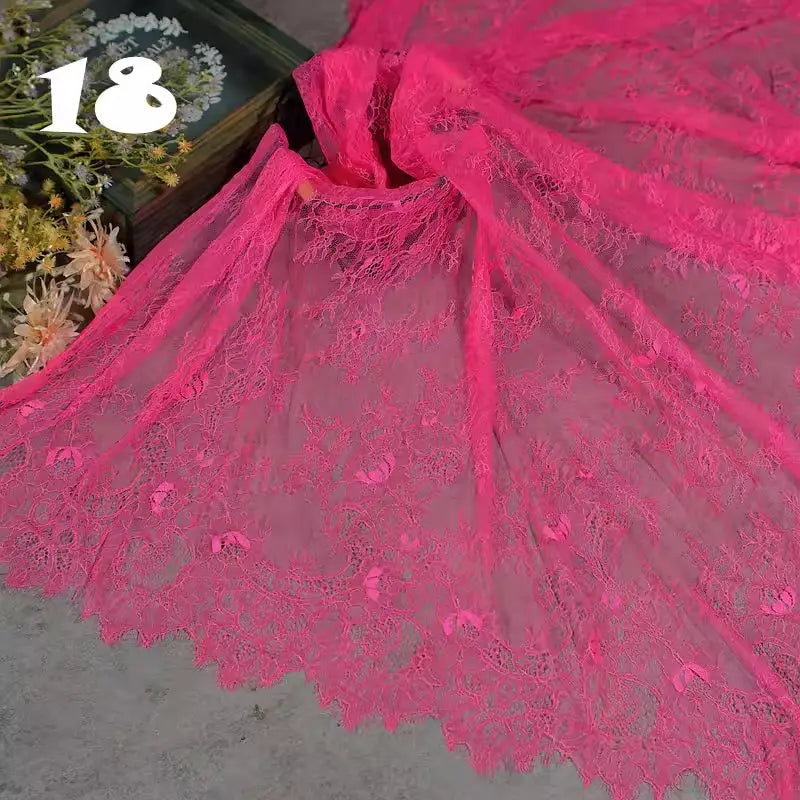 Longan Craft's Colorful Floral Embroidered Lace Fabric by the yard with vintage scalloped edges is displayed beside a wooden box of dried flowers. Bold white "18" appears in the upper left corner.