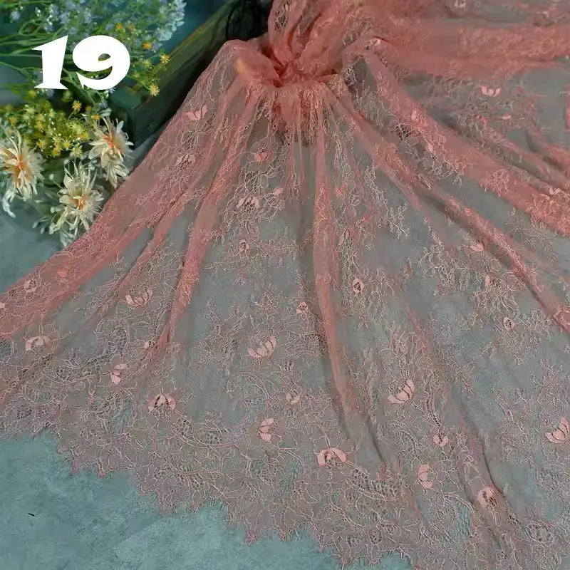 Longan Craft’s Colorful Floral Embroidered Lace Fabric by the yard, a vintage scalloped lace with botanical patterns, is displayed beside white and yellow flowers. The number 19 appears in bold white text on the upper left.