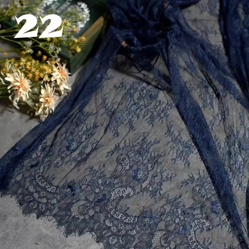 Longan Craft's Colorful Floral Embroidered Lace Fabric, featuring a vintage scalloped botanical pattern, is displayed beside yellow and white flowers and a green box. The number 22 appears in the top left corner.