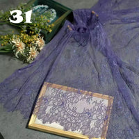 A piece of Longan Craft's Colorful Floral Embroidered Lace Fabric By The Yard, featuring a vintage scalloped botanical pattern, is displayed on a wooden frame with flowers in the background. The number 31 appears in white at the top left.