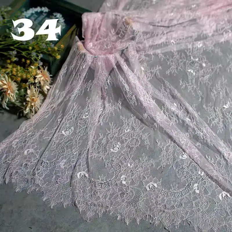 Colorful Floral Embroidered Lace Fabric by Longan Craft is displayed on a gray surface with dried flowers in a green box. The number 34 is shown in bold white text at the top left. Perfect for wedding gowns and vintage projects.