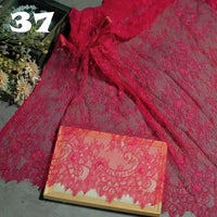 Longan Craft’s Colorful Floral Embroidered Lace Fabric by the yard is displayed with a scalloped botanical pattern sample in a wooden frame. The number 37 appears in the corner, and a bouquet of flowers sits nearby.