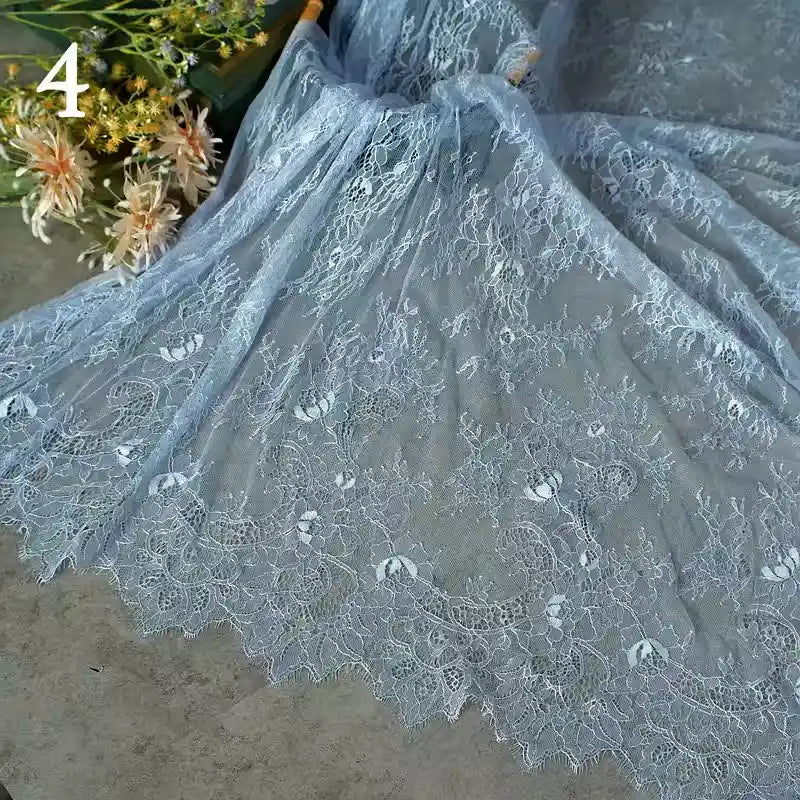 Colorful floral embroidered lace fabric by Longan Craft, featuring vintage scalloped edges and botanical patterns, is spread out beside artificial flowers. The number 4 appears in the upper left corner.