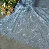 Colorful floral embroidered lace fabric by Longan Craft, featuring vintage scalloped edges and botanical patterns, is spread out beside artificial flowers. The number 4 appears in the upper left corner.