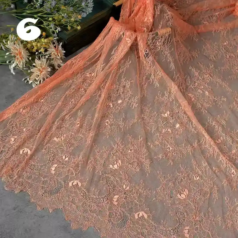 Longan Craft’s Colorful Floral Embroidered Lace Fabric by the yard is displayed, highlighting its vintage scalloped edges and botanical pattern. A bouquet and the number 6 are visible in the background. Perfect for delicate wedding gowns.