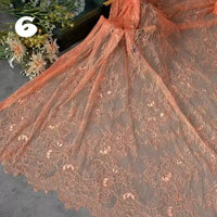 Longan Craft’s Colorful Floral Embroidered Lace Fabric by the yard is displayed, highlighting its vintage scalloped edges and botanical pattern. A bouquet and the number 6 are visible in the background. Perfect for delicate wedding gowns.