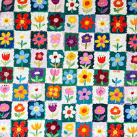 Colorful Floral Print Canvas Fabric By The Yard featuring a checkered pattern of squares, each containing a painted flower on 100% cotton canvas.