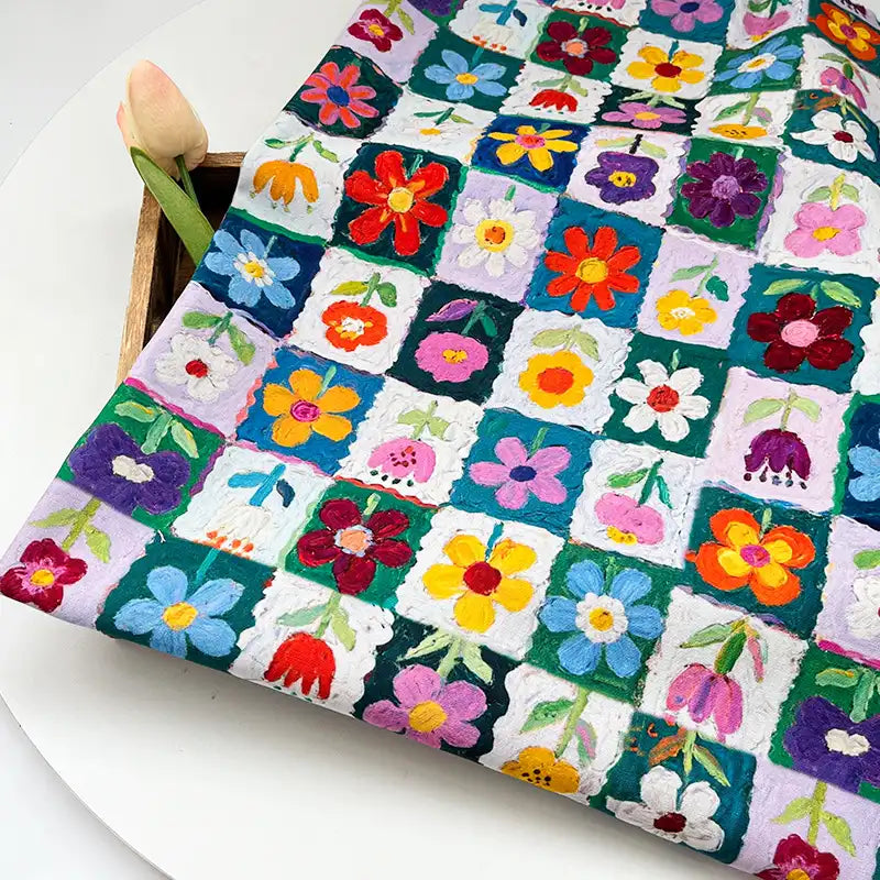 Colorful Floral Print Canvas Fabric By The Yard featuring a grid pattern of squares, each containing a different embroidered colorful flower.