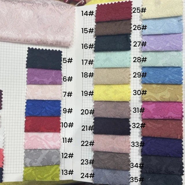 The Longan Craft Colorful Jacquard Damask Fabric sample book features 24 numbered floral-patterned upholstery swatches, perfect for home décor and available by the yard—ideal for your next project.