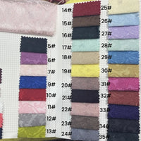 The Longan Craft Colorful Jacquard Damask Fabric sample book features 24 numbered floral-patterned upholstery swatches, perfect for home décor and available by the yard—ideal for your next project.