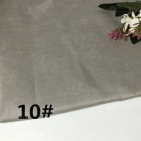 A light gray fabric from Longan Craft’s “Colorful Lightweight Ramie Fabric By The Yard” collection is shown flat, with “10#” printed in black on the bottom left. A small bouquet of flowers decorates the upper right corner.