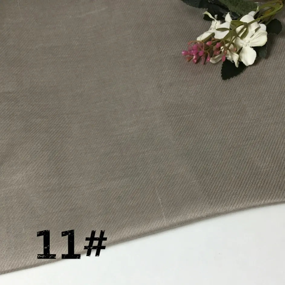 A swatch of Colorful Lightweight Ramie Fabric by the yard from Longan Craft is shown in light brown with a subtle diagonal texture. Small white and pink flowers accent the top right corner, while “11#” is displayed in bold black text at the bottom left.