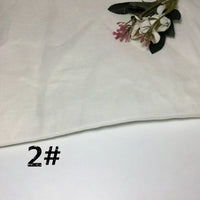 An off-white piece of Longan Craft’s Colorful Lightweight Ramie Fabric By The Yard is displayed on a white surface, accompanied by artificial pink and white flowers in the top right corner. The number “2#” is printed in black at the bottom left.