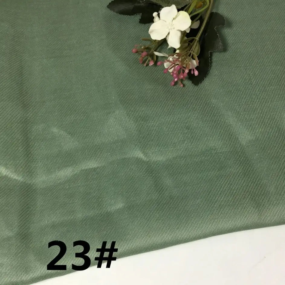 A piece of Colorful Lightweight Ramie Fabric By The Yard by Longan Craft in a light green shade, featuring a small artificial floral arrangement in the corner and the number 23# printed in black in the bottom left.