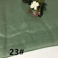 A piece of Colorful Lightweight Ramie Fabric By The Yard by Longan Craft in a light green shade, featuring a small artificial floral arrangement in the corner and the number 23# printed in black in the bottom left.