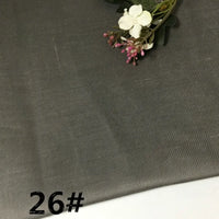 The Colorful Lightweight Ramie Fabric by the yard from Longan Craft features a soft, solid color pure ramie material adorned with delicate white flowers and greenery in the corner. The number 26# is boldly printed in black at the bottom left.