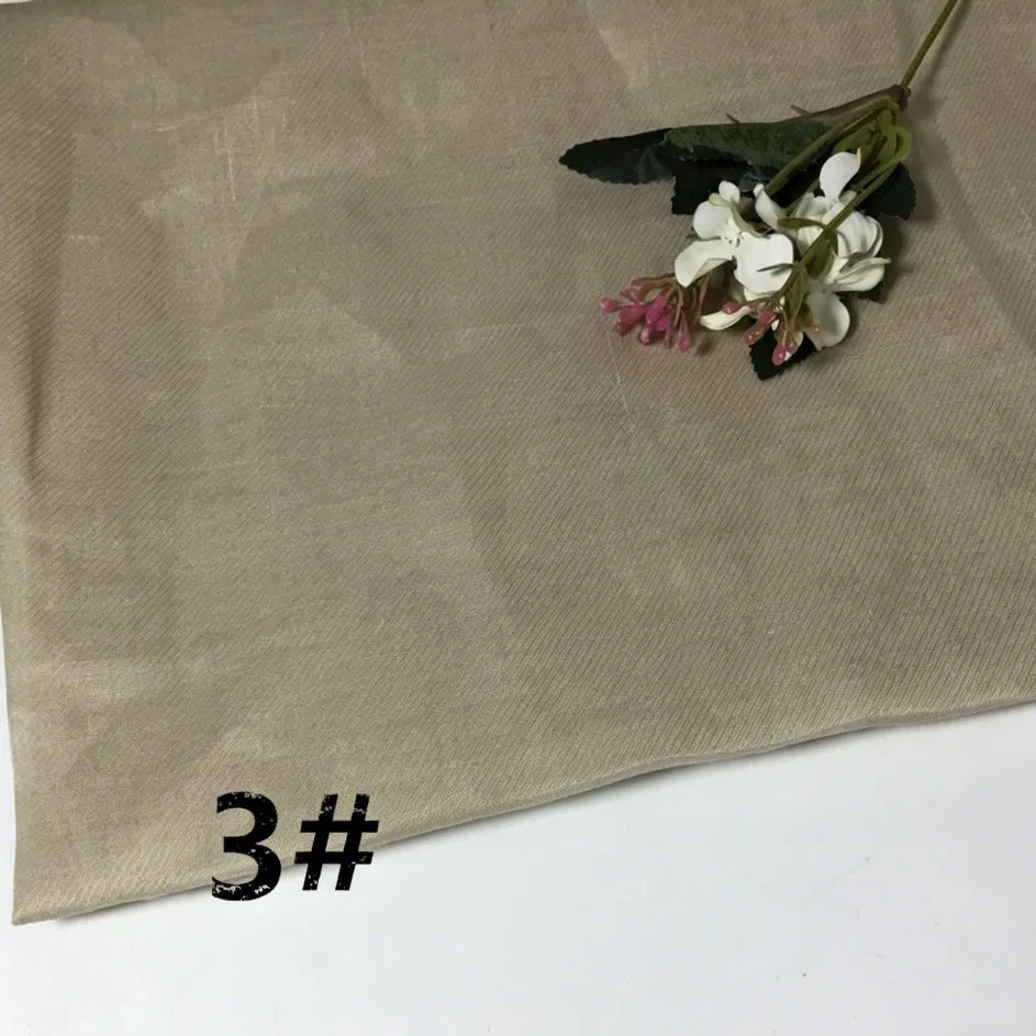 A sheet of Longan Craft Colorful Lightweight Ramie Fabric By The Yard in beige is displayed, with a small bouquet of white and pink flowers on top and the text “3#” printed in black in the lower left corner.