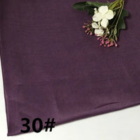 A section of the Longan Craft Colorful Lightweight Ramie Fabric By The Yard in a dark purple shade is shown, accompanied by a cluster of white and pink artificial flowers in one corner. The solid color, pure ramie material appears soft and perfect for garment making. The number 30# is displayed in bold black text at the bottom left.