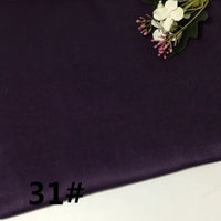 A piece of deep purple, lightweight solid color pure ramie fabric from Longan Craft’s “Colorful Lightweight Ramie Fabric By The Yard” collection, featuring a small floral arrangement in the top right corner. The number 31# is printed in black in the bottom left corner.