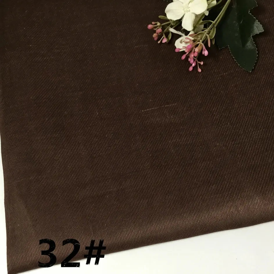 A sample of Longan Craft’s Colorful Lightweight Ramie Fabric By The Yard, in a brown shade with a subtle diagonal texture, is displayed alongside a small artificial flower arrangement in the corner. The number 32# appears in bold black text in the lower left corner.