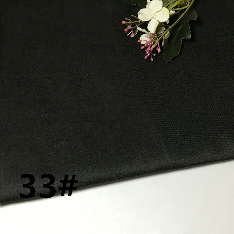 A swatch of Longan Craft’s Colorful Lightweight Ramie Fabric in black, featuring a soft, breathable texture and a small bouquet of artificial flowers in one corner; the number 33# is boldly printed on the fabric’s surface.