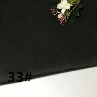 A swatch of Longan Craft’s Colorful Lightweight Ramie Fabric in black, featuring a soft, breathable texture and a small bouquet of artificial flowers in one corner; the number 33# is boldly printed on the fabric’s surface.