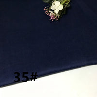 A piece of Colorful Lightweight Ramie Fabric By The Yard from Longan Craft in a dark blue shade is laid out flat with a small artificial flower arrangement placed on top. The number 35# is printed in black on the lower left corner.