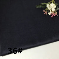 A piece of Longan Craft Colorful Lightweight Ramie Fabric By The Yard in dark navy blue is shown laid flat, featuring a small artificial flower arrangement in the top right corner and the number 36# in bold black text at the lower left.