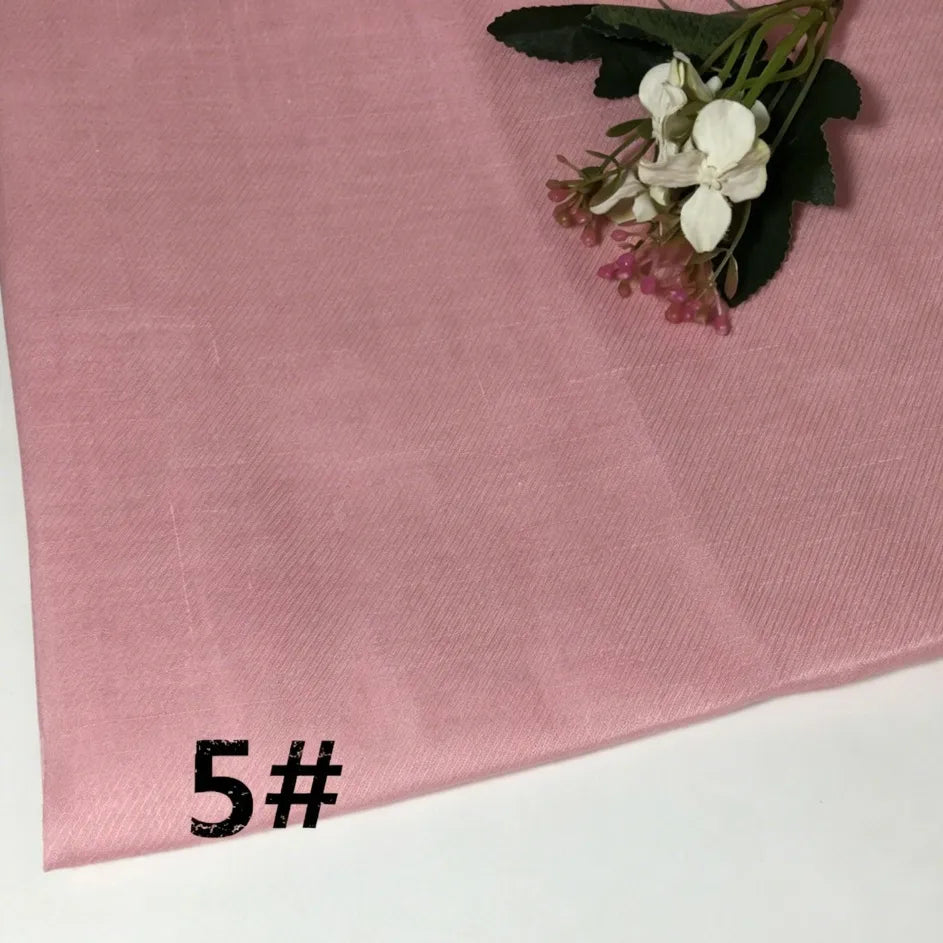 A length of light pink Longan Craft Colorful Lightweight Ramie Fabric By The Yard is laid out, with a small bouquet of white and pink flowers resting on top. The number 5# is printed in bold black text in the lower left corner.