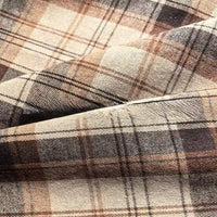 Close-up of the Colorful One Side Sueded Flannel Fabric By The Yard from Longan Craft, featuring intersecting lines in brown and beige yarn-dyed plaid, highlighting the soft, textured folds of this super snuggle cotton flannel material.