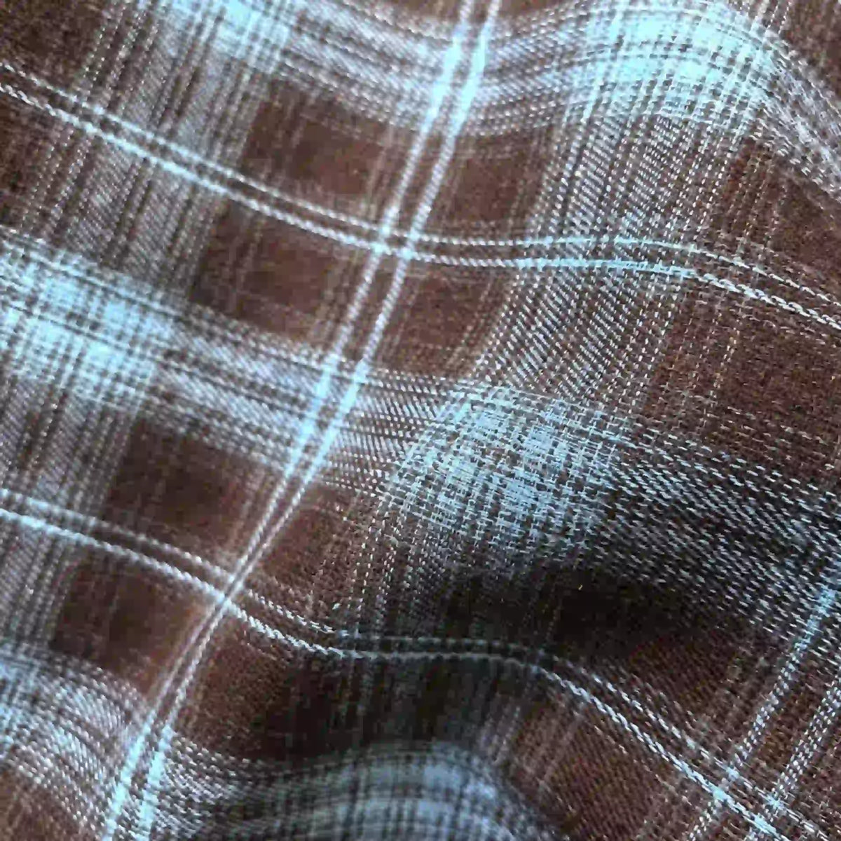 Close-up of Longan Craft Colorful One Side Sueded Flannel Fabric by the Yard, featuring a soft, yarn-dyed cotton plaid with visible texture and gentle folds; intersecting horizontal and vertical lines create a checkered pattern in this super snuggle fall flannel material.