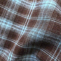 Close-up of Longan Craft Colorful One Side Sueded Flannel Fabric by the Yard, featuring a soft, yarn-dyed cotton plaid with visible texture and gentle folds; intersecting horizontal and vertical lines create a checkered pattern in this super snuggle fall flannel material.