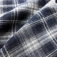 Close-up of Longan Craft’s Colorful One Side Sueded Flannel Fabric By The Yard, a yarn dyed cotton plaid flannel featuring a navy blue and white pattern with intersecting lines and a soft, textured sueded surface, slightly wrinkled—perfect as a Super Snuggle Fall Flannel Material.