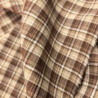 Close-up of Longan Craft’s Colorful One Side Sueded Flannel Fabric By The Yard, a super snuggle fall material made from yarn dyed cotton with a brown and beige plaid pattern, featuring a soft sueded texture and visible weave detail.