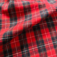 A close-up of the Longan Craft Colorful One Side Sueded Flannel Fabric By The Yard, a yarn dyed cotton plaid flannel featuring intersecting lines and checkered red and black patterns with a slightly wrinkled texture—perfect as a super snuggle fall material.