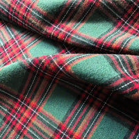 Close-up of Longan Craft’s Colorful One Side Sueded Flannel Fabric By The Yard, a yarn-dyed cotton plaid flannel with a green, red, and black tartan pattern, highlighting its super snuggle texture and soft folds.