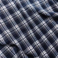 Close-up of the Longan Craft Colorful One Side Sueded Flannel Fabric By The Yard, a super snuggle fall material made from yarn dyed cotton. The fabric features a navy blue, white, and gray plaid pattern with intersecting horizontal and vertical stripes forming squares. The one side sueded surface appears soft and slightly wrinkled.