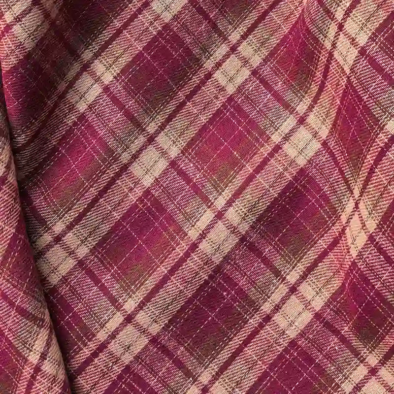 Close-up of Longan Craft’s Colorful One Side Sueded Flannel Fabric by the yard, featuring a super snuggle yarn dyed cotton plaid design in red, pink, and beige. The image highlights the intersecting lines and the soft, textured surface of this fall flannel material.