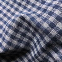 Close-up of Longan Craft’s Colorful One Side Sueded Flannel Fabric By The Yard, a yarn dyed cotton plaid flannel with a blue and white checkered pattern. The brushed surface is textured and slightly wrinkled, forming a grid of small squares characteristic of Super Snuggle Fall Flannel Material.
