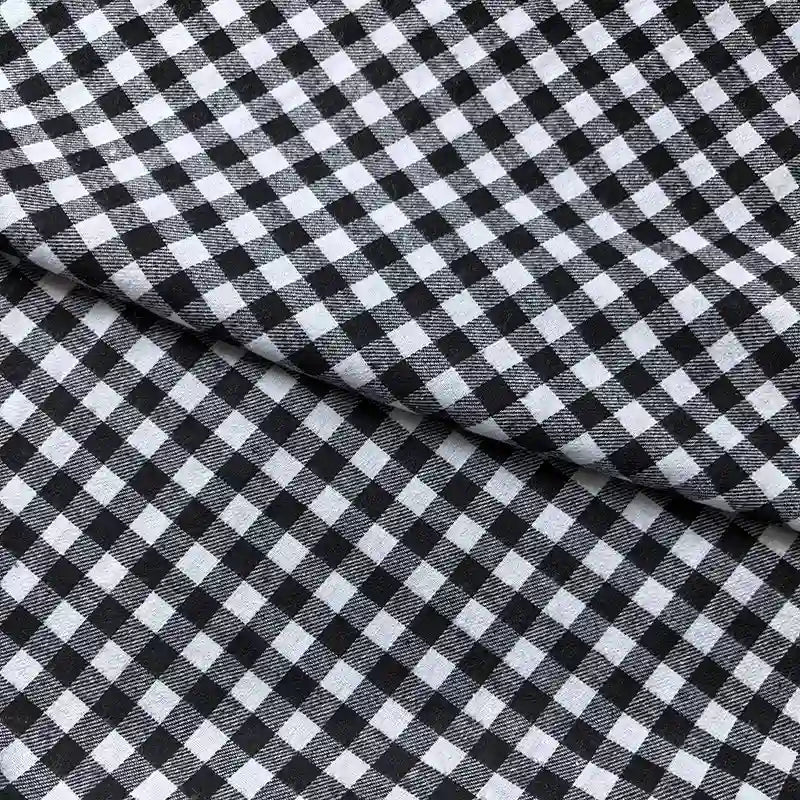 A close-up of Longan Craft Colorful One Side Sueded Flannel Fabric by the yard, featuring a yarn-dyed cotton plaid pattern with an overlapping fold in the center of the image, highlighting the super snuggle flannel material.