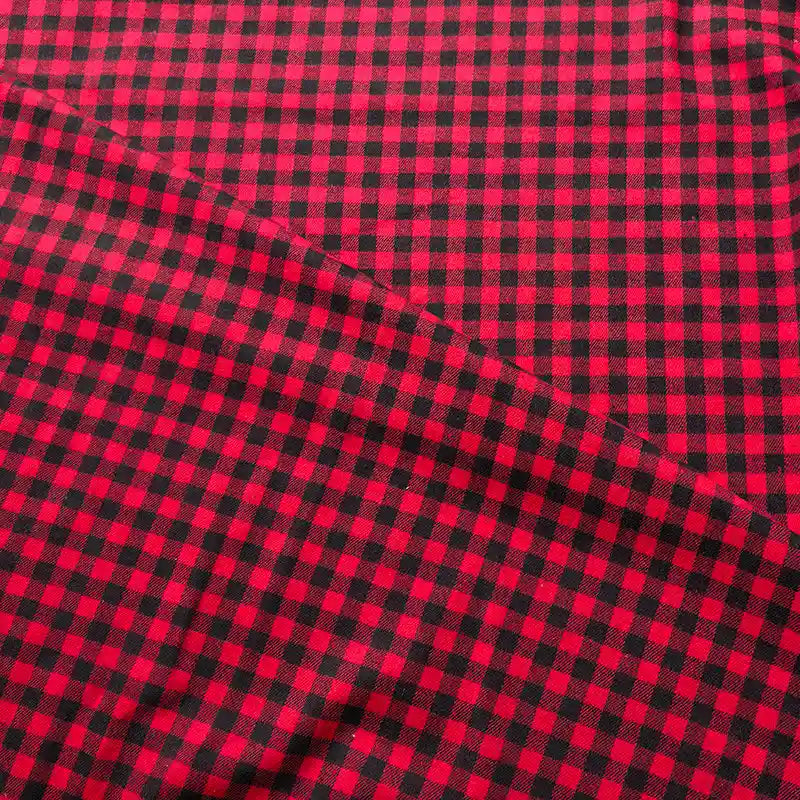 The Colorful One Side Sueded Flannel Fabric by the Yard from Longan Craft features a yarn dyed cotton plaid design in classic red and black checks, with a vibrant pattern and a soft texture that’s beautifully highlighted by a diagonal fold near the center.