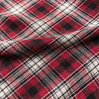 Close-up of the Colorful One Side Sueded Flannel Fabric By The Yard from Longan Craft, featuring a classic red, black, and white yarn-dyed plaid pattern; intersecting lines and squares emphasize its timeless design, while the slightly wrinkled, brushed cotton flannel reveals the super snuggle softness and natural folds of this premium fall material.