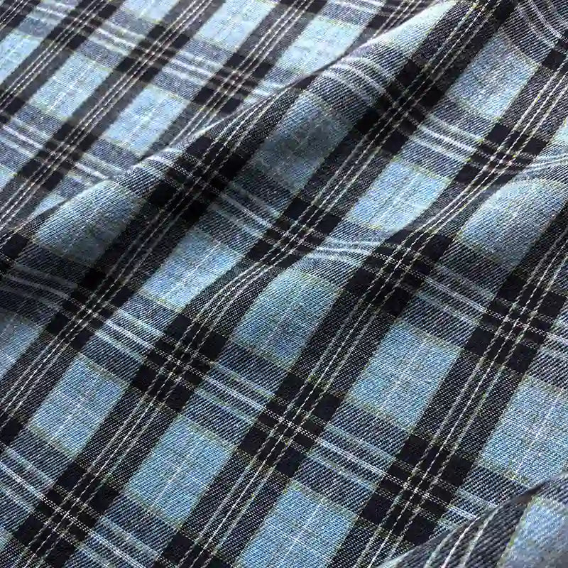 Longan Craft Colorful One Side Sueded Flannel Fabric by the Yard features a blue and black yarn-dyed cotton plaid design with crisp white lines forming a checkered pattern. This super snuggle fall flannel material boasts a slightly wrinkled, textured finish, ideal for cozy projects.
