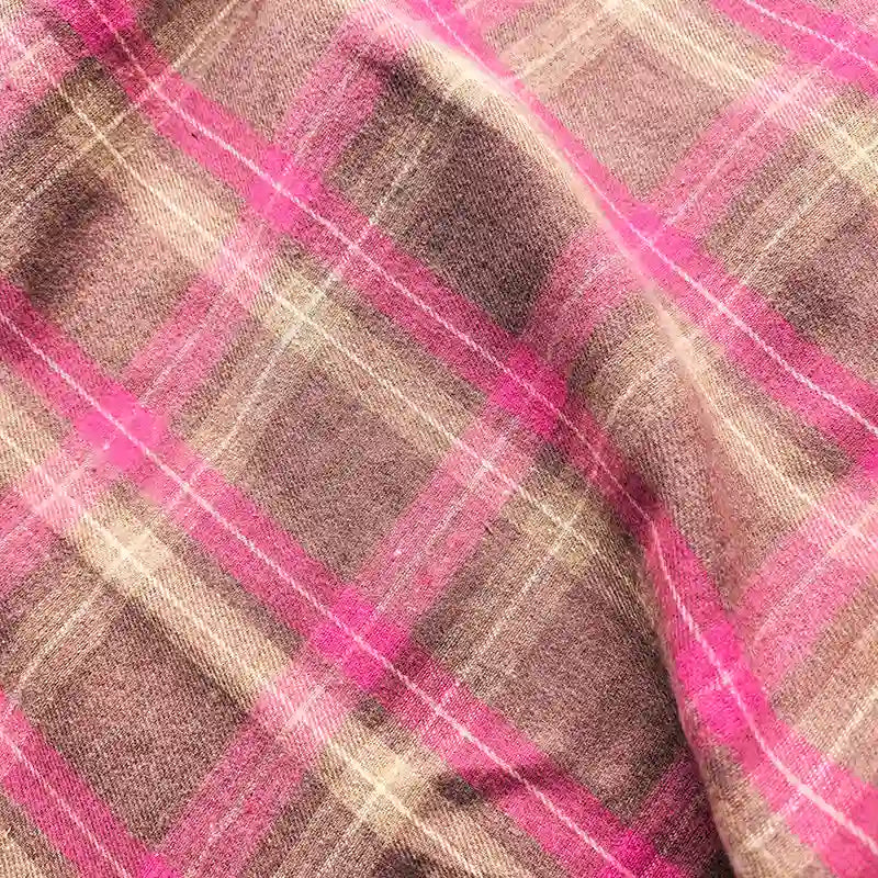 A close-up of Longan Craft’s Colorful One Side Sueded Flannel Fabric By The Yard, a yarn dyed cotton plaid flannel featuring pink and beige tones, with a soft, textured surface and visible creases—perfect for super snuggle fall projects.