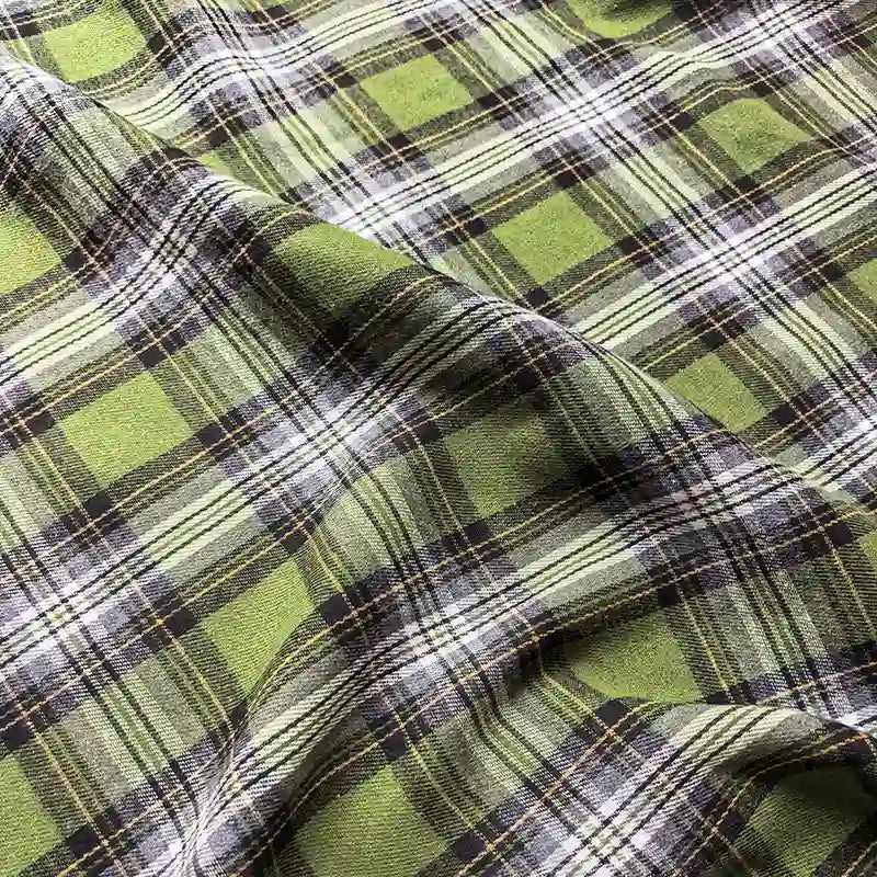 Close-up of the Colorful One Side Sueded Flannel Fabric by Longan Craft, featuring a soft, yarn-dyed green, black, and white plaid cotton with a gentle drape and cozy sueded texture.