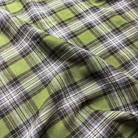 Close-up of the Colorful One Side Sueded Flannel Fabric by Longan Craft, featuring a soft, yarn-dyed green, black, and white plaid cotton with a gentle drape and cozy sueded texture.